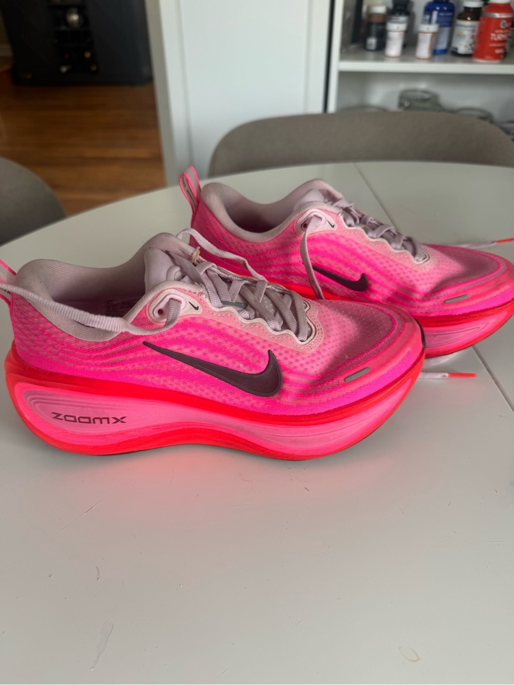 Nike ZoomX running sneakers in a bright pink colorway.